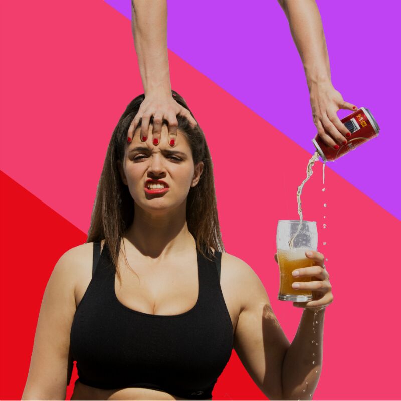 A woman holds a beer while another women, doing a one armed handstand on her head, pours the first woman her beer.