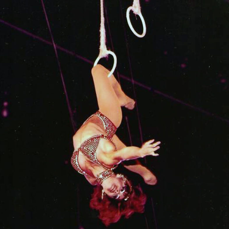 Dolly Jacobs performs a knee hang on the Roman Rings