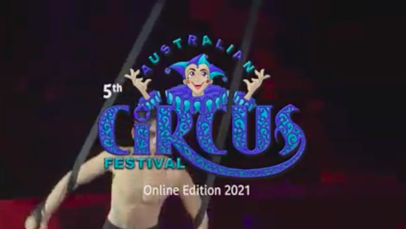 A man performs straps behind the Australian Circus Festival logo