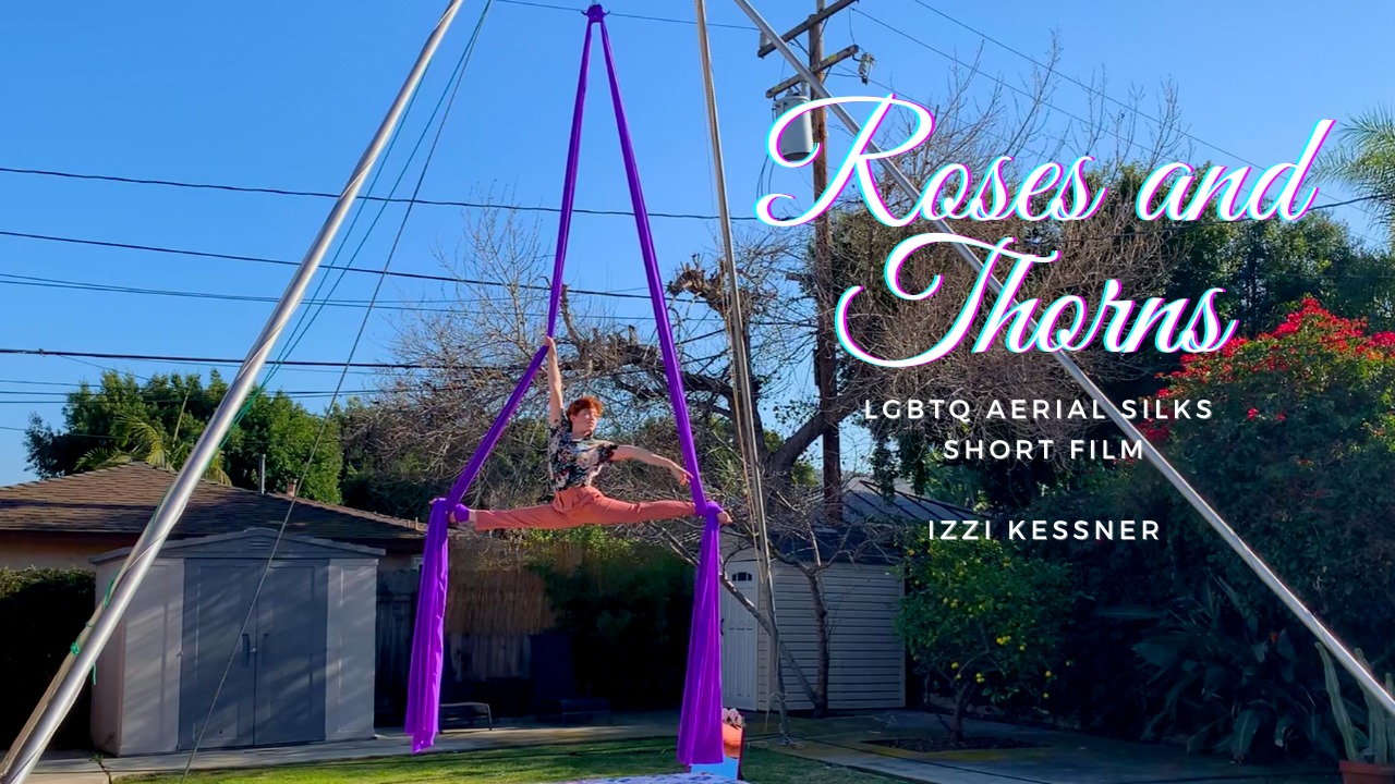 Izzi Kessner does a split on a purple pair of silks outside