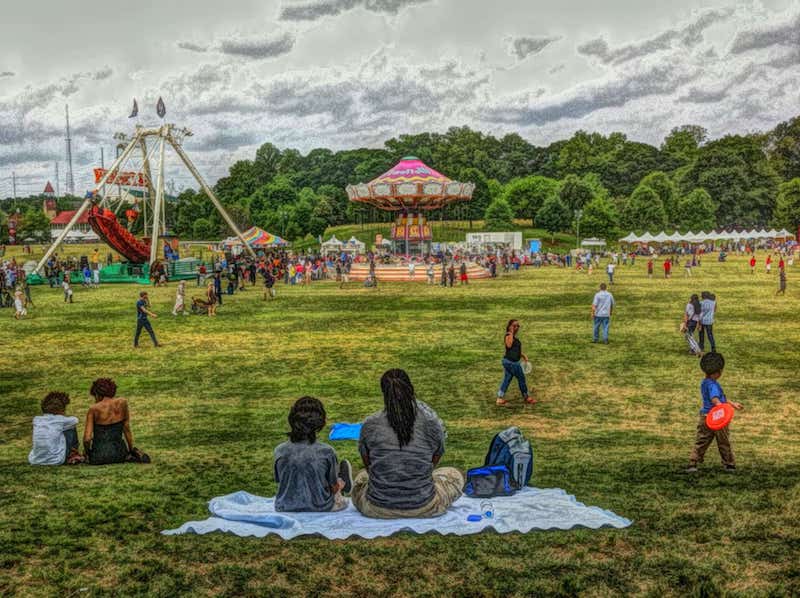 A digital rendering of families sitting on picnic blankets outside the circus