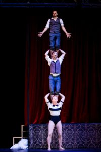 Three circus performers in a three high. Rowan Hayden-White bases.