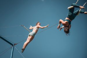 Woman catching a partner on flying trapeze
