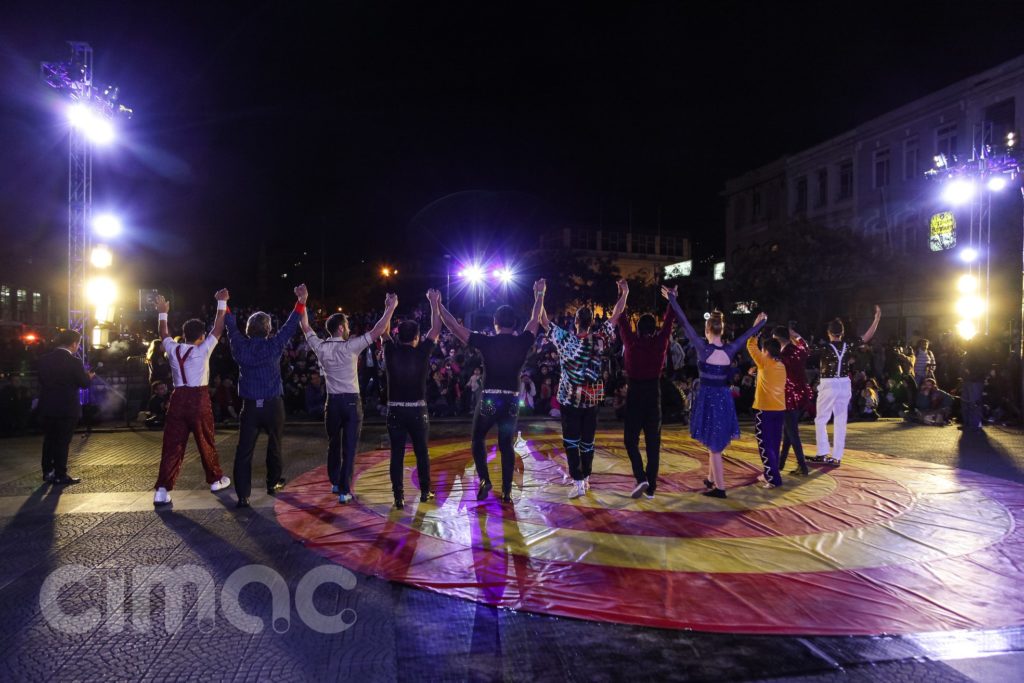 CIMAC artists hold hands and bow in the street