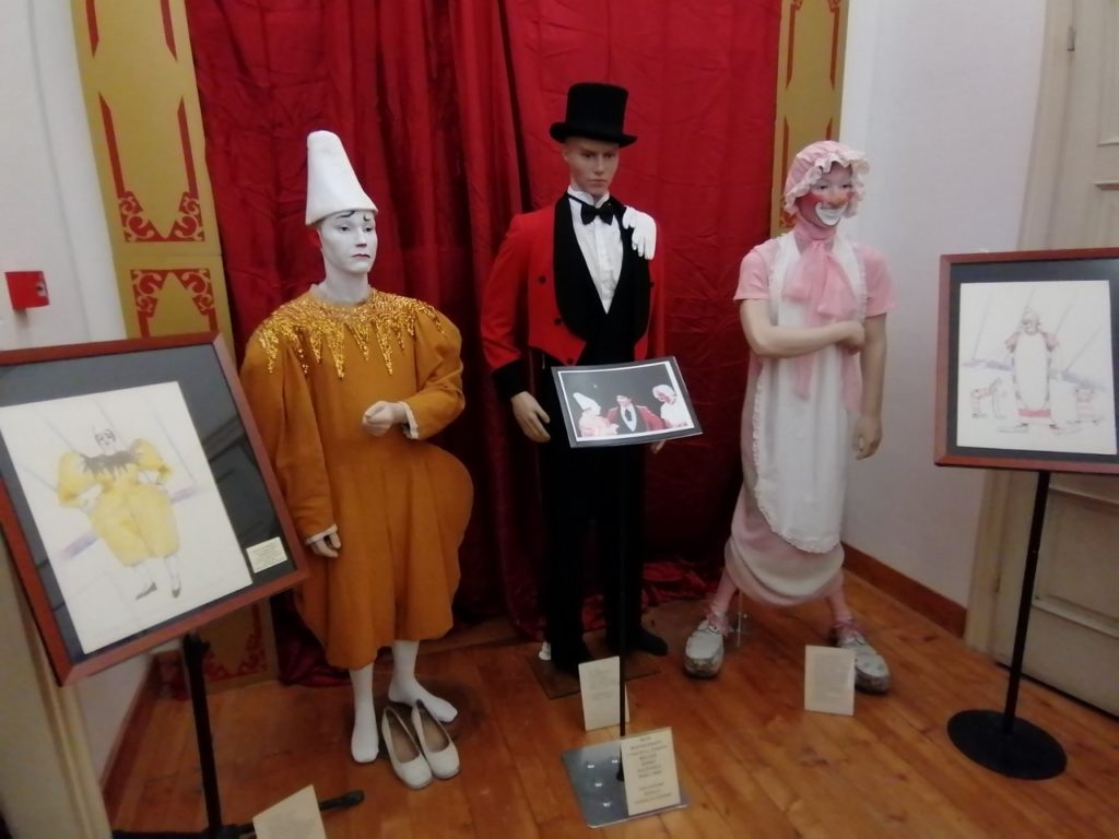 Mannequins sport circus costumes in a display