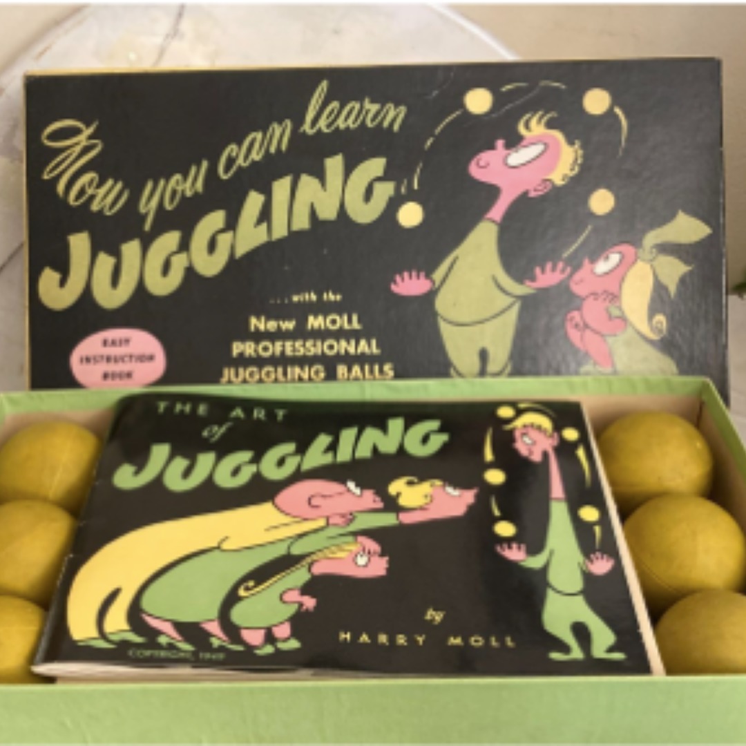 Benjamin Domask-Ruh's Harry Moll Juggling Kit (made 1949), a green and black box with six yellow balls