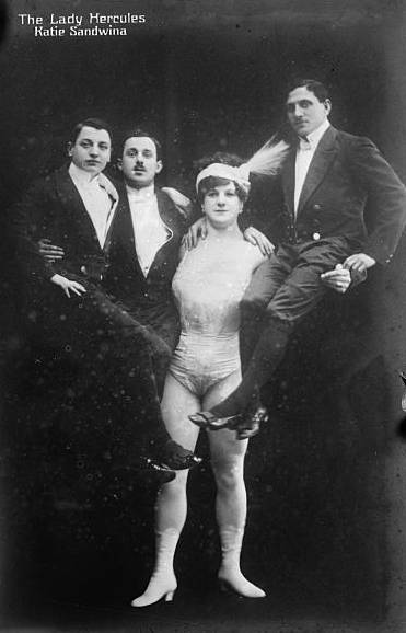 Circus strongwoman Katie Sandwina, a.k.a "the Lady Hercules," holds three men