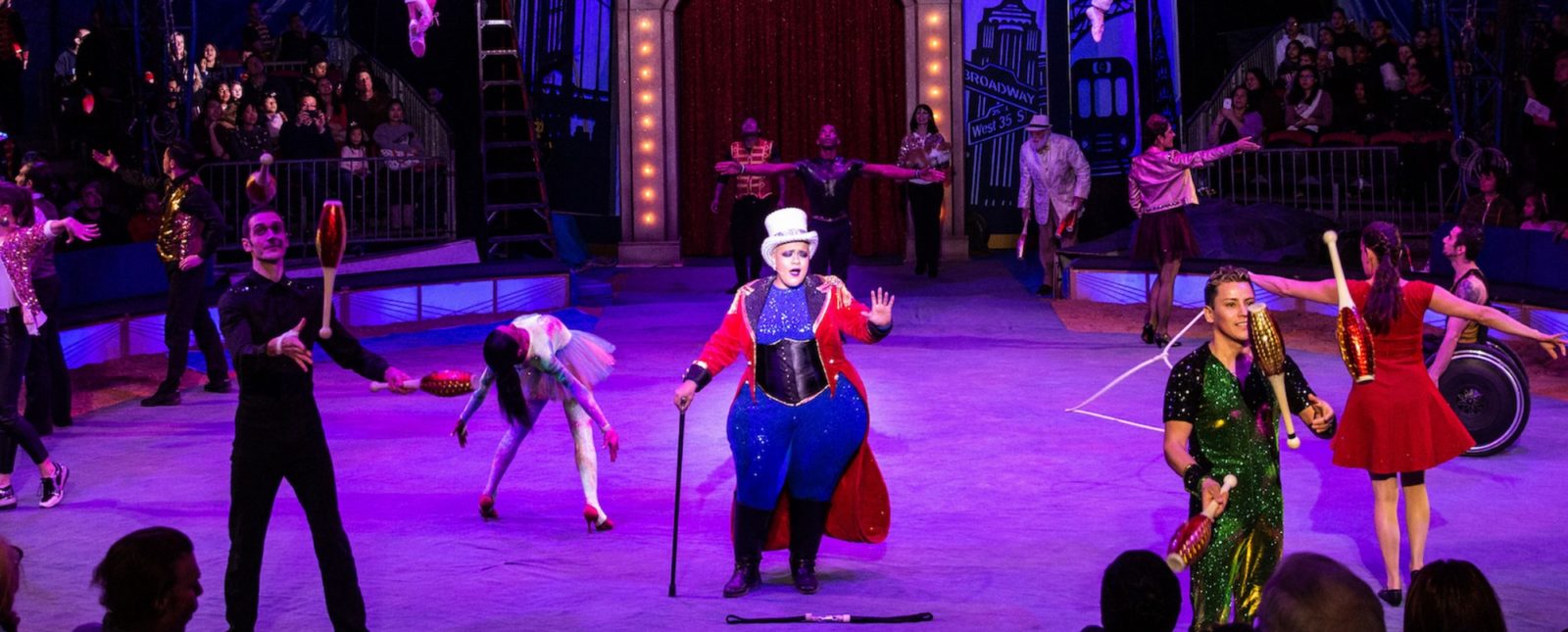 Much like a circus advocate for the ACA, a Big Apple Circus ringmaster supports the acrobats, pin jugglers, and aerialists in the circus ring around her