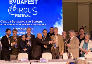At the Circus Buildings in Europe Conference, a panel of circus history experts stands in front of a Budapest Circus Festival banner