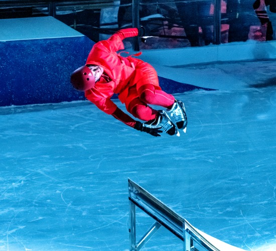 In CADENCE, ice-skating and circus show, a performer leaps off a ramp