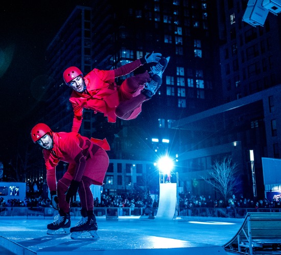 In CADENCE, In CADENCE, ice-skating and circus show, two ice skaters in red jumpsuits perform a trick