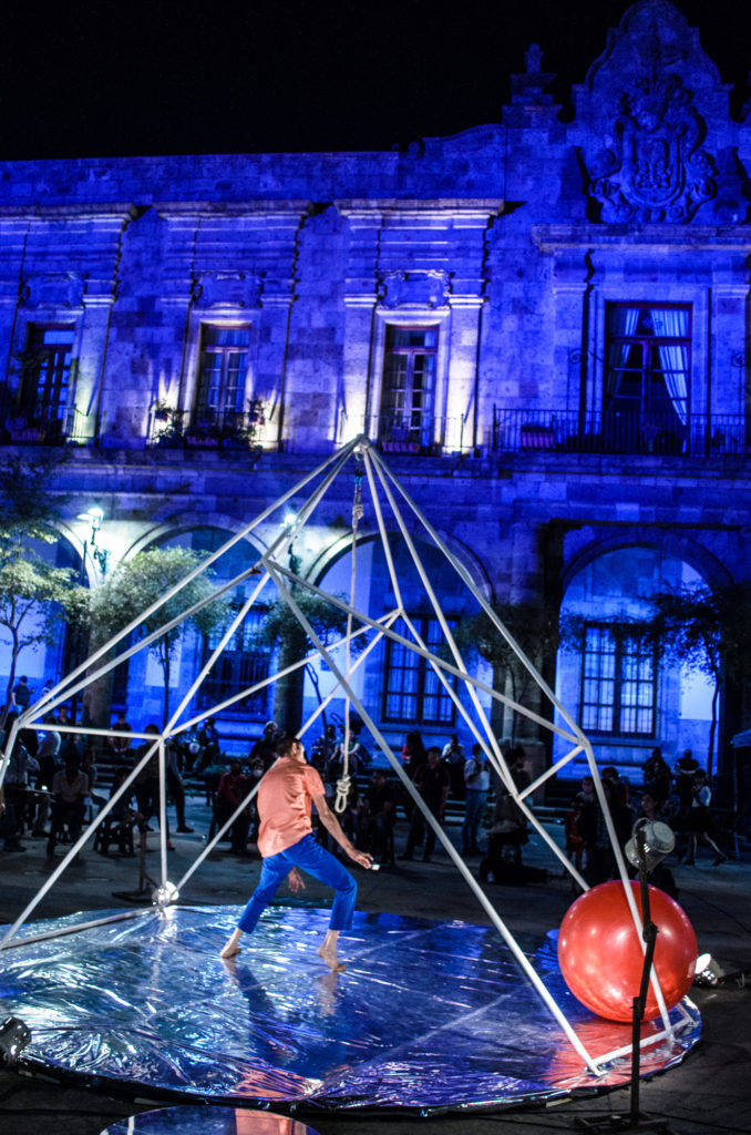 Circus show "Disonante" in Guadalajara, Mexico. An acrobat poses under a triangular apparatus outside the Hospico Cabanas