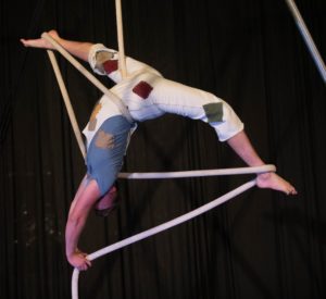Doug Stewart, circus performer and Cirque Us founder, does a backbend while entwined in rope