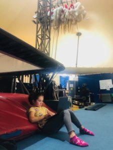 Alice, circus performer Ginger Griep-Ruiz's daughter, on her laptop backstage in a gymnastics training studio