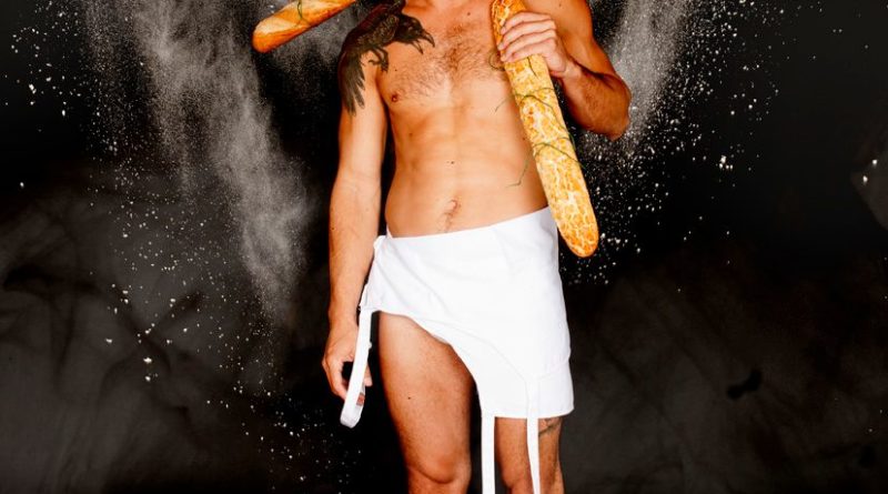 Circus performer JD Brousse in (le) Pain, his solo show. Brousse holds a cross made of French baguettes over his shoulder.