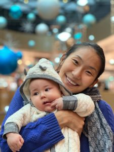 Ulziibuyan (Ulzii) Mergen Kee smiles and holds her baby son 