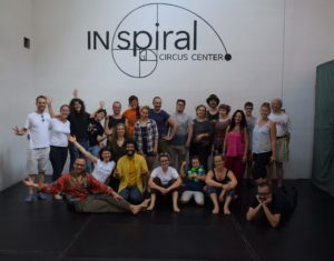 At the first Functional Juggling Convention, international jugglers pose for a diverse group photo in front of the INspiral Circus Center logo