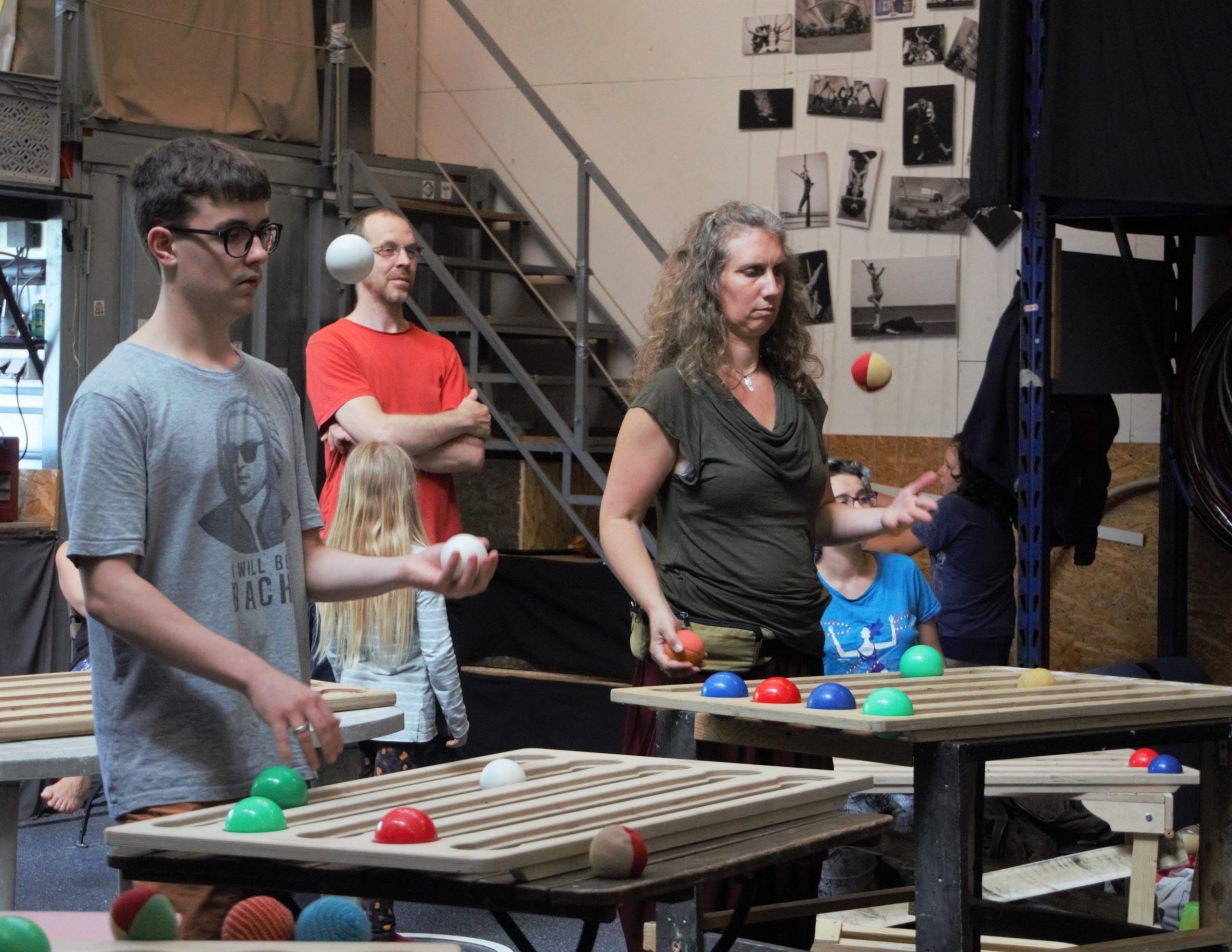 In an INspiral Circus Center classroom, three jugglers practice over functional juggling boards