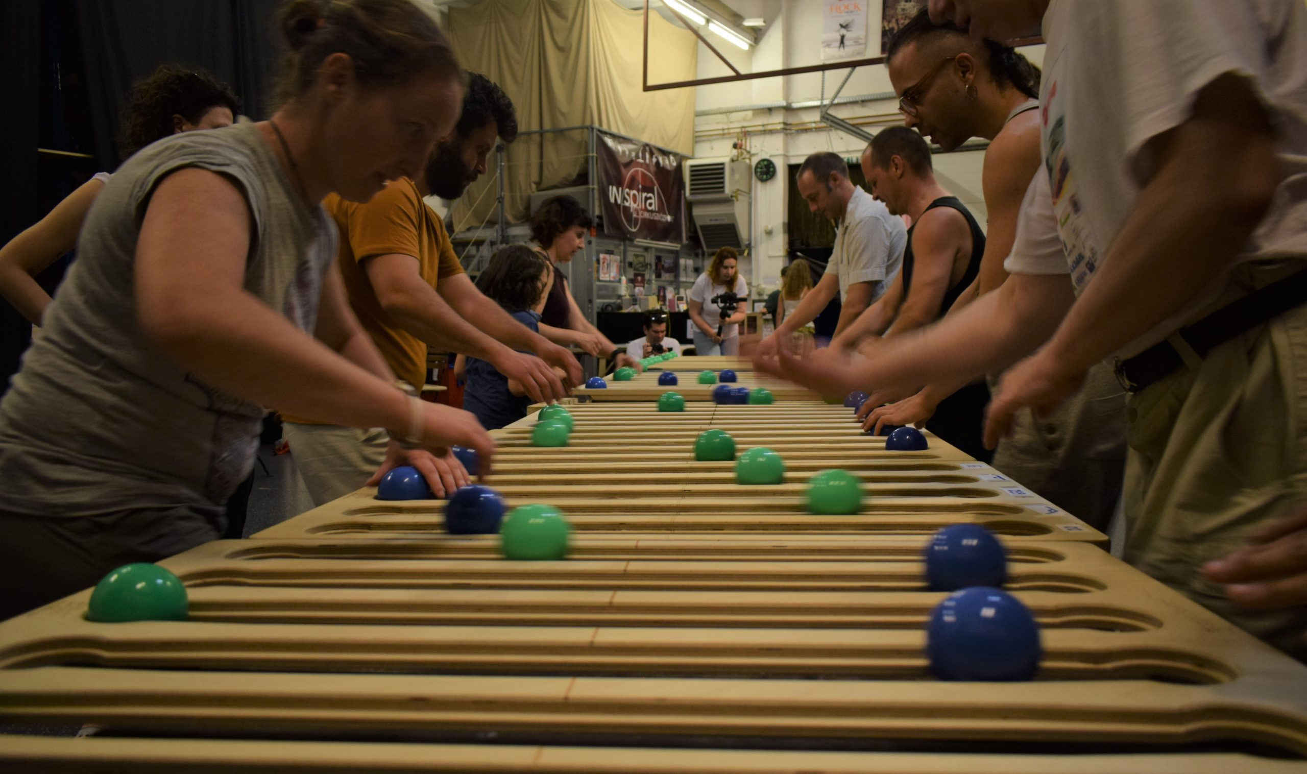 Functional Juggling practitioners stand side-by-side around Quat Prop rectangular juggling boards. This convention took place inside the INspiral Circus Center