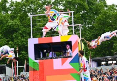 Cirque Bijou performers at the Queen's Platinum Jubilee Pageant. On a colorful box stage, the performers swing from ropes and trapezes