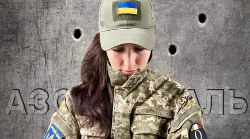 Nadya Vasina, Ukrainian circus performer, activist, and Radio Kyiv FM journalist, wears camo and a cap with the Ukrainian flag to show support for Ukraine