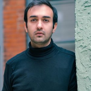 Sohrab Haghverdi, an Iranian experimental theatre artist based in Philadelphia, who will appear at Cannonball for Philadelphia Fringe 2022. He is a young Arab man in a black turtleneck, with a short beard.