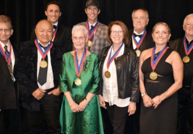 At the World Acrobatics Society's 2022 Hall of Fame Ceremony, the nine inducted athletes and performers wear their medals for a group photo