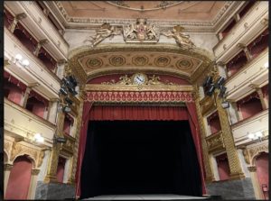 Interior of the Civico Teatro Toselli in Cuneo, Italy. This is a 19th-century designed theater with a grand stage and balcony seats