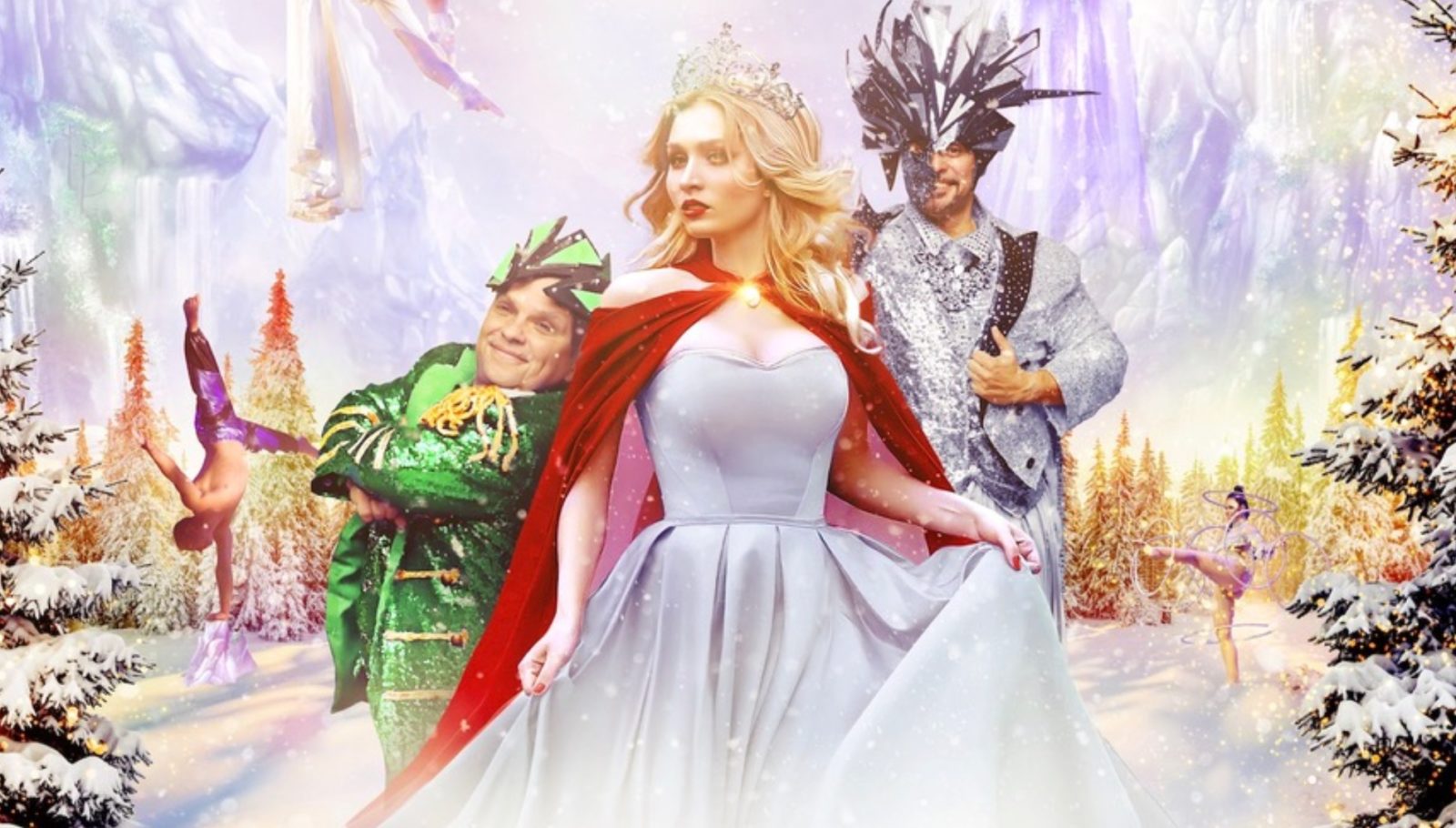 In Cirque Musica's 2022 holiday show, a female circus performer in a white gown and red cloak stands between a child performer in a Christmas tree costume and a man in a silver and brown costume with an antlered mask