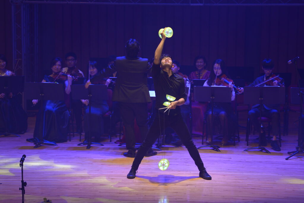 Malaysian diabolo artist Hng Thean Leong performs his act before a large in-house orchestra