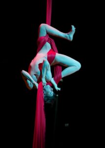 Aerialist Tanya Burka performs on red aerial silks in the show 