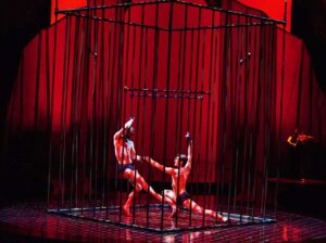 Two Cirque du Soleil male dancers, including Arnaud Boursain, perform inside a cage for the Vegas show 