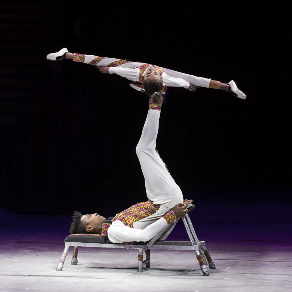 The Gamo brothers, two Ethiopian acrobats in white clothes, perform their Icarian Games act
