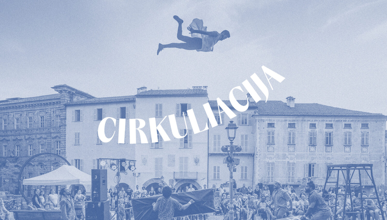 A circus artist flies above the audience outdoors at the Cirkuliacija Contemporary Circus