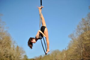 Aerialist Kalista Russell trains on an outdoor lyra hoop 