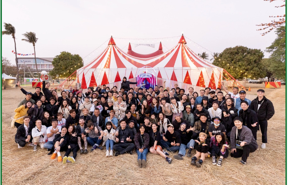 Performers of the first FOCASA Circus Art Festival in Tainan City take a large group photo in front of the red-and-white-striped circus tent
