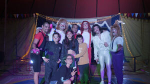 The Castro circus family, still wearing stage makeup, takes a family photo inside the tent
