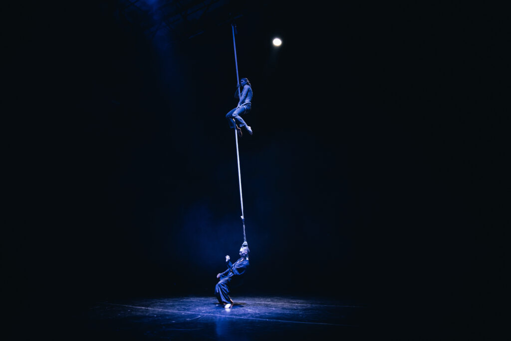 Circus collective Art for Rainy Days' "How the Spiral Works" features an hair-hang act where one performer climbs the long rope attached to another performer's braid